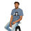 Thumbnail: Man sitting wearing Slate blue Uh Oh Hot Dog T-shirt featuring Bobby Lee's face and quote.