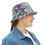 Thumbnail: Woman wearing a metallic holographic bucket hat with a denim jacket and white t-shirt, adjusting the brim of the hat.