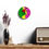 Thumbnail: The Kiss wall clock with bright pink, green, and yellow design.