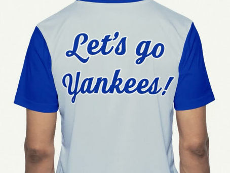 Person wearing a "Let's go Yankees!" shirt, viewed from behind, with blue and white team colors.