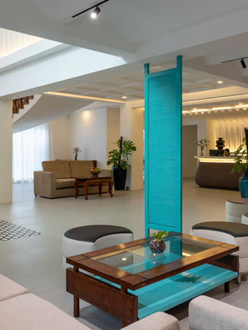 Modern hotel lobby with sofas and curved staircase