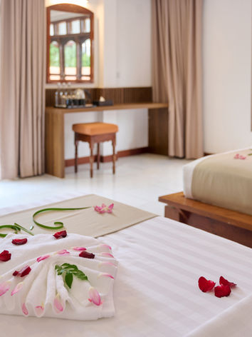 Modern hotel room with twin beds and flower petal decor