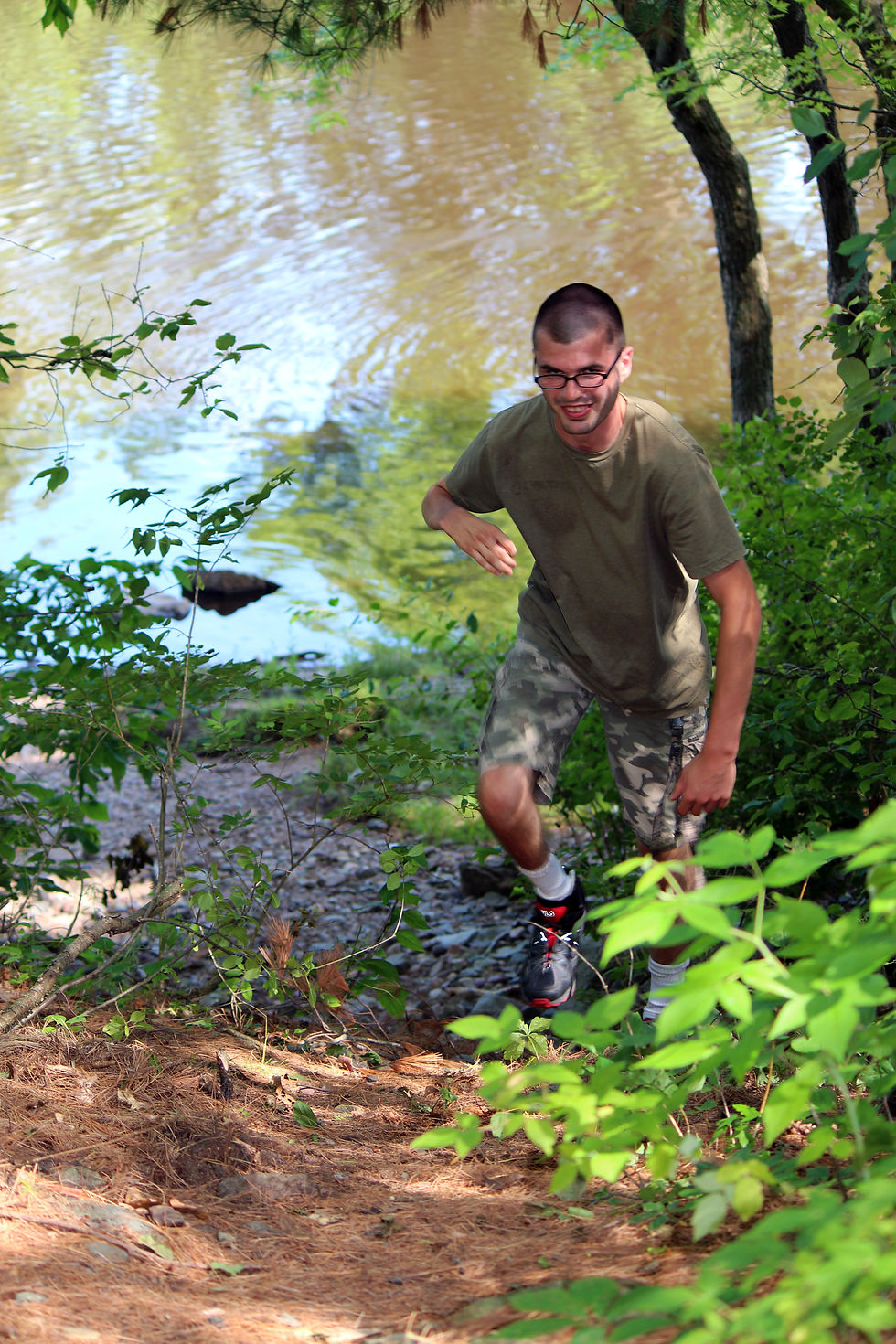 Man with CP climbing hill in forest