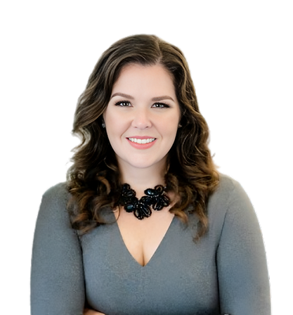 Professional headshot of Carina de la Torre, a smiling woman with long wavy brown hair, wearing a gray V-neck sweater and a black statement necklace, with her arms crossed.