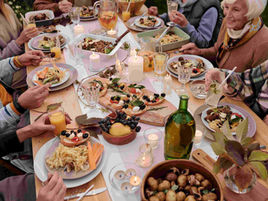 A warm outdoor family dinner with diverse dishes and joyful conversation