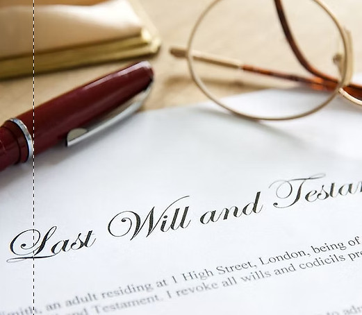 Last will and testament document with eyeglasses and pen on desk, representing Florida estate planning and a surviving spouse’s rights in probate