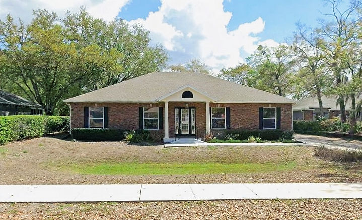 Exterior of Tower Law Group main office in Oviedo, Florida, located at 800 Executive Drive in a professional office complex with landscaped surroundings and accessible parking