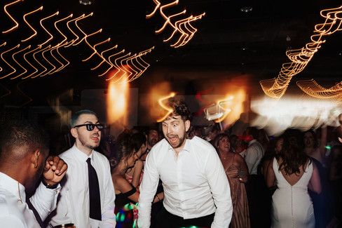 A wedding guest partying on the dance floor