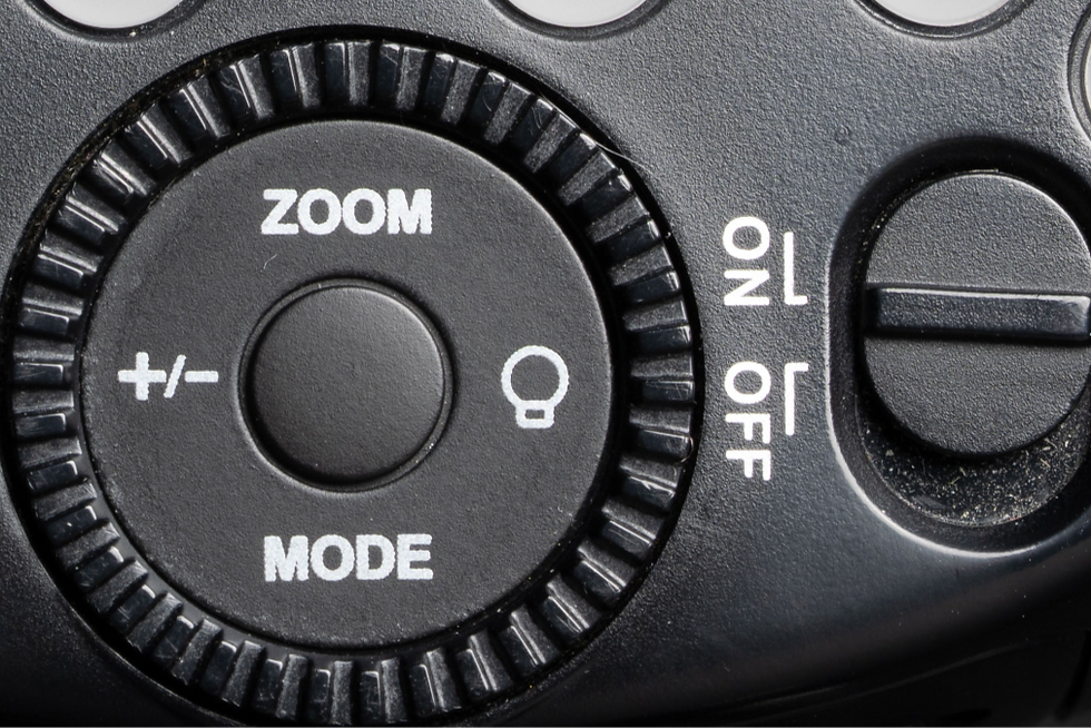 Close image of the modeling light button on a Godox V1