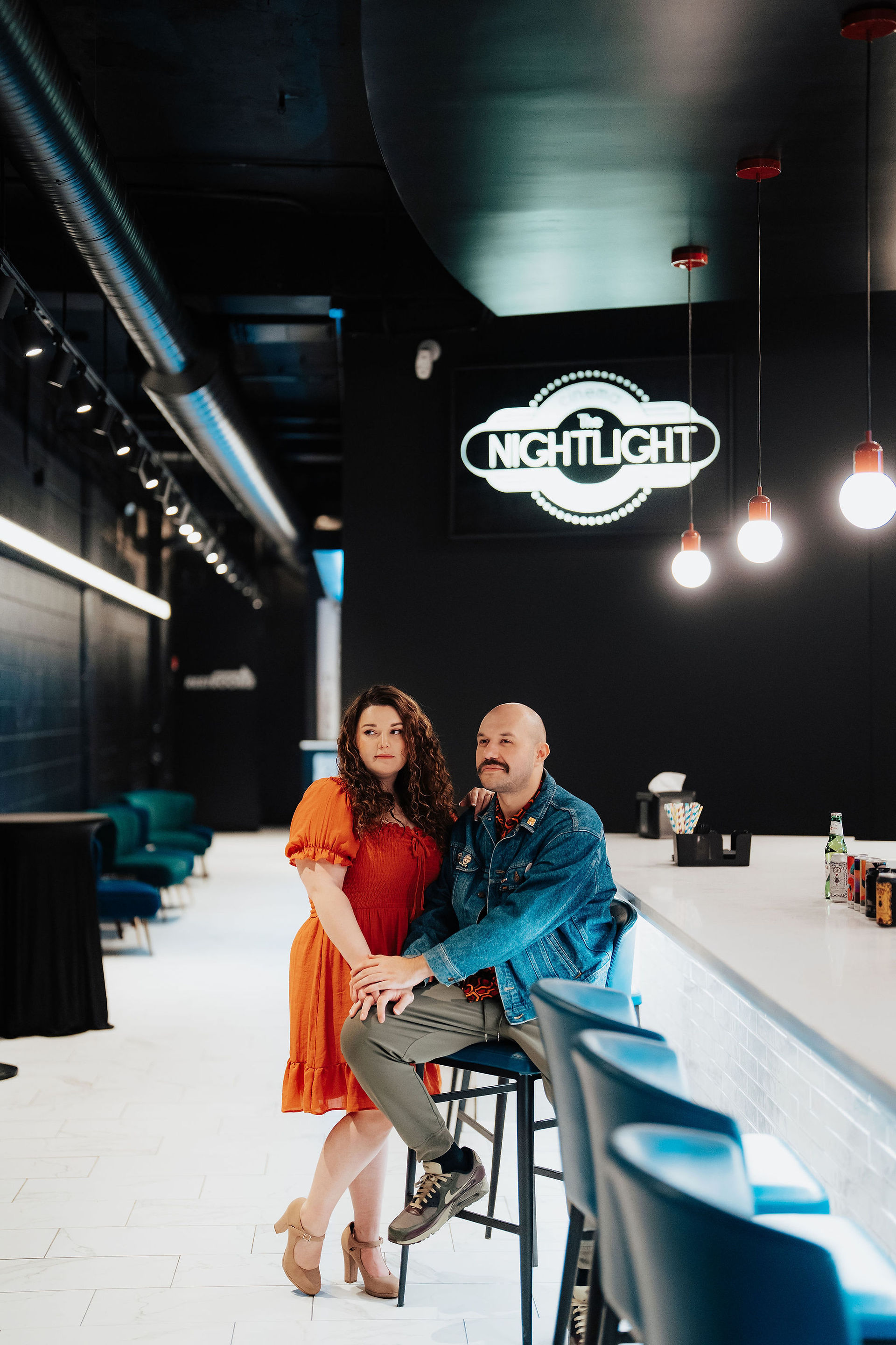 a couple posing in a movie theater lobby