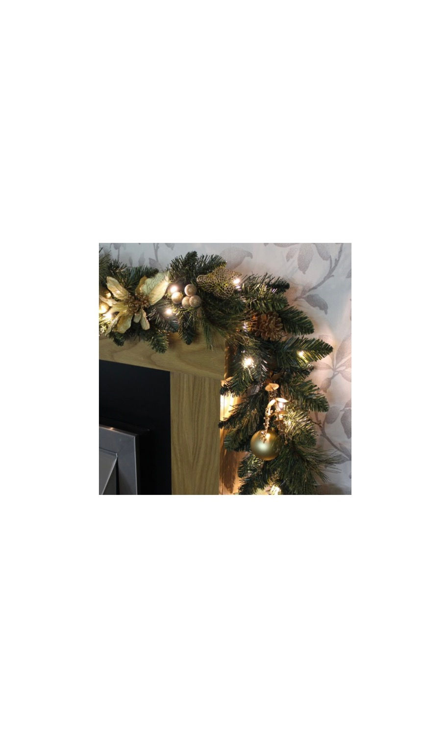 الصورة المصغرة: Christmas garland with lights and ornaments decorated on a fireplace mantel.