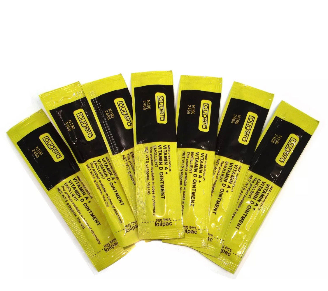 Several yellow and black packets, each with visible text, on white background.