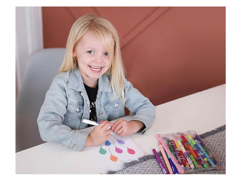 Thumbnail: Happy blonde girl drawing with colorful markers at a white table.