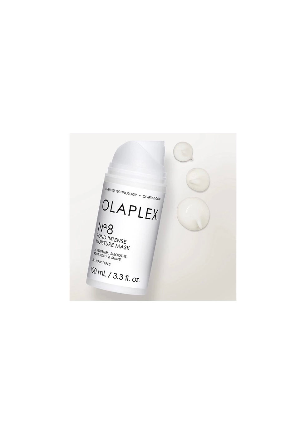 Miniaturebillede: White Olaplex No.8 Bond Intense Moisture Mask bottle and product drops on white surface.