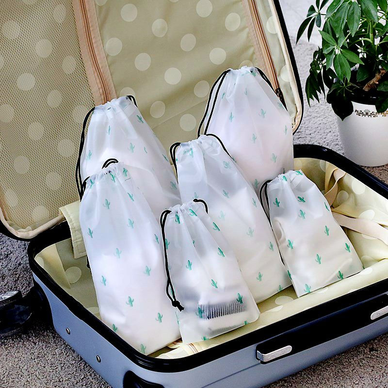 Miniatyrbild: White travel pouches in open suitcase. Ready to pack and organize. 