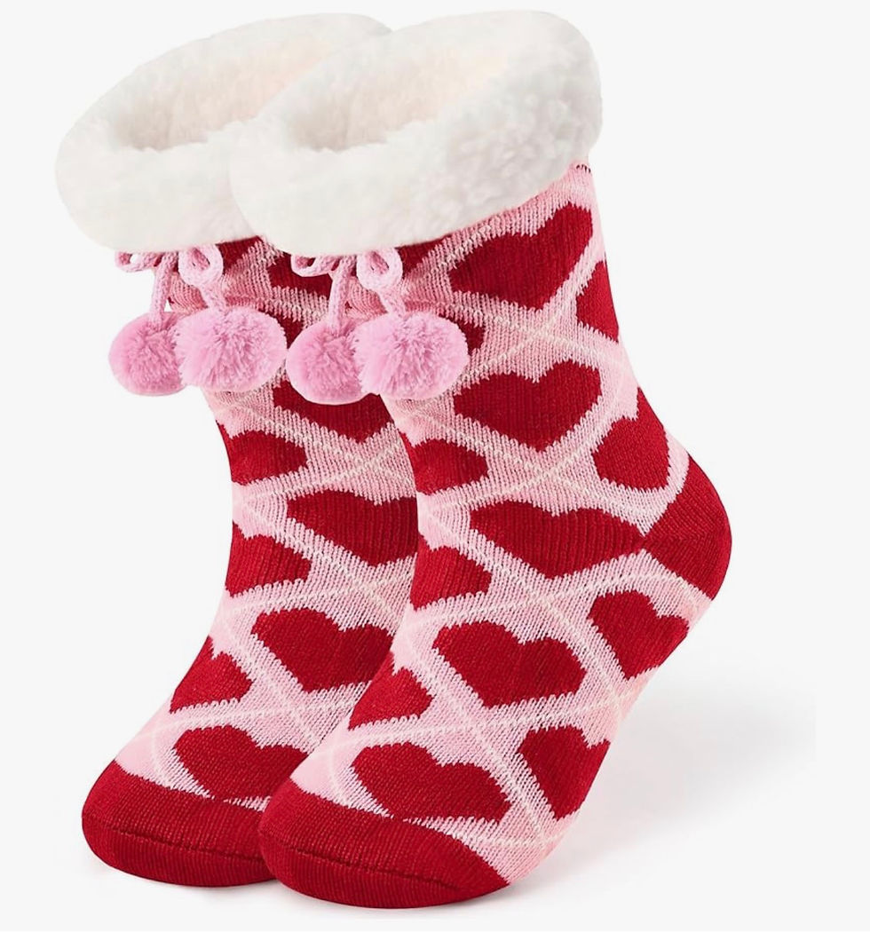 Thumbnail: Cozy pink slipper socks featuring red hearts, white fluffy cuff, and pom-poms.