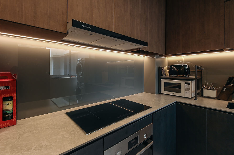 Sink counter with grey glass backsplash 