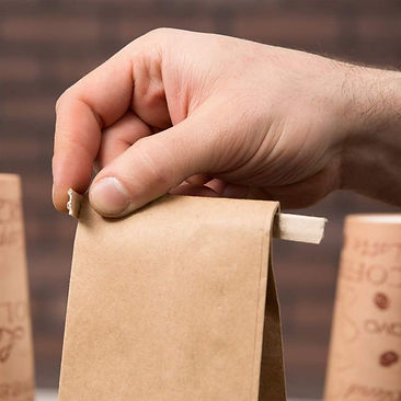 Mano cerrando bolsa con cierre Tin Tie