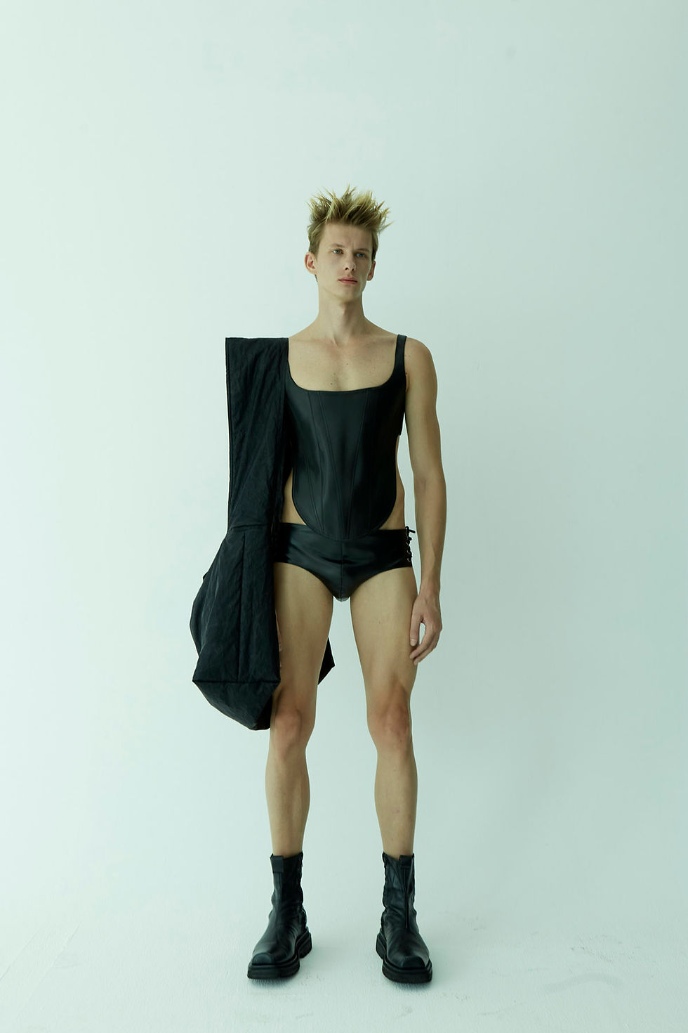 Thumbnail: The choice of material—smooth, black vegan leather—evokes a sense of boldness and edginess, typically associated with alternative fashion styles. 