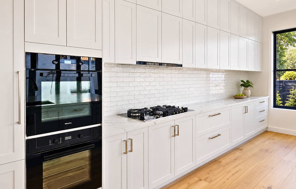 Completed kitchen renovation project in Moonee Ponds featuring shaker-style cabinetry, stone benchtops, and subway tile splashback.
