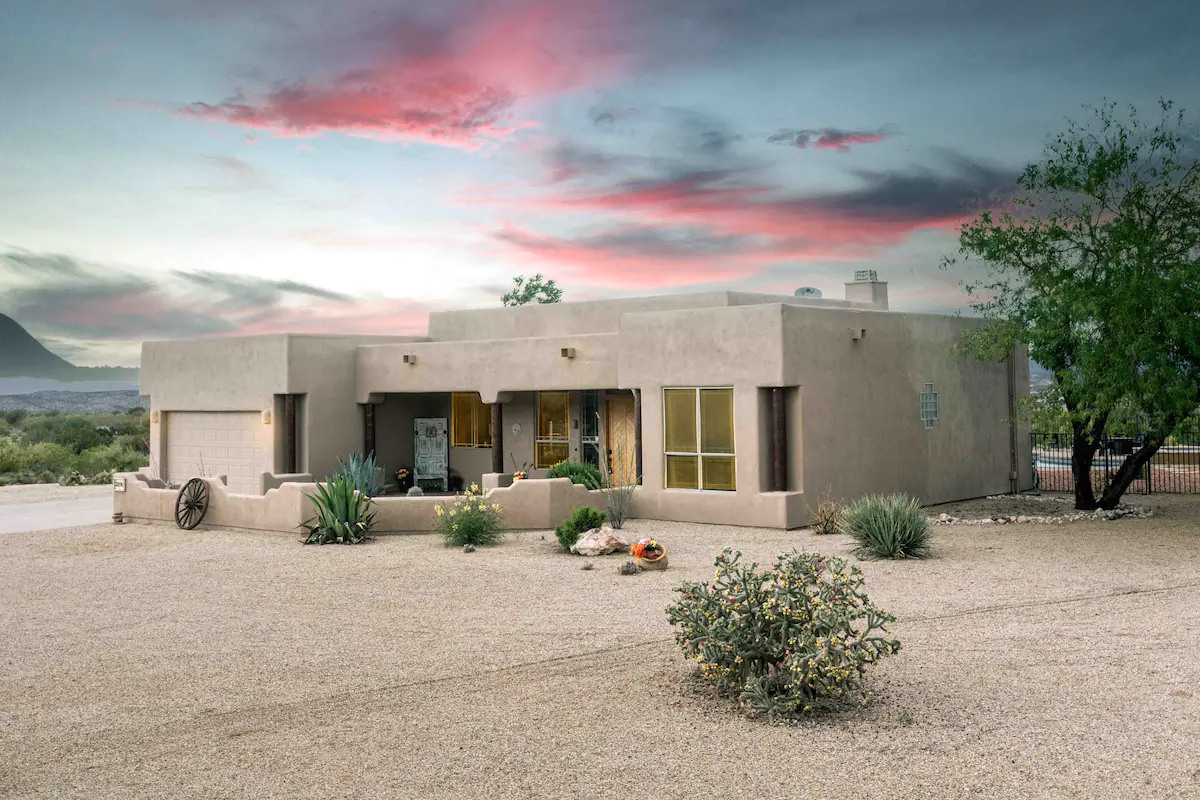 A southwestern charm home with a pink skies.