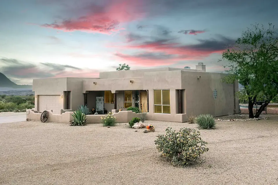 A southwestern charm home with a pink skies.