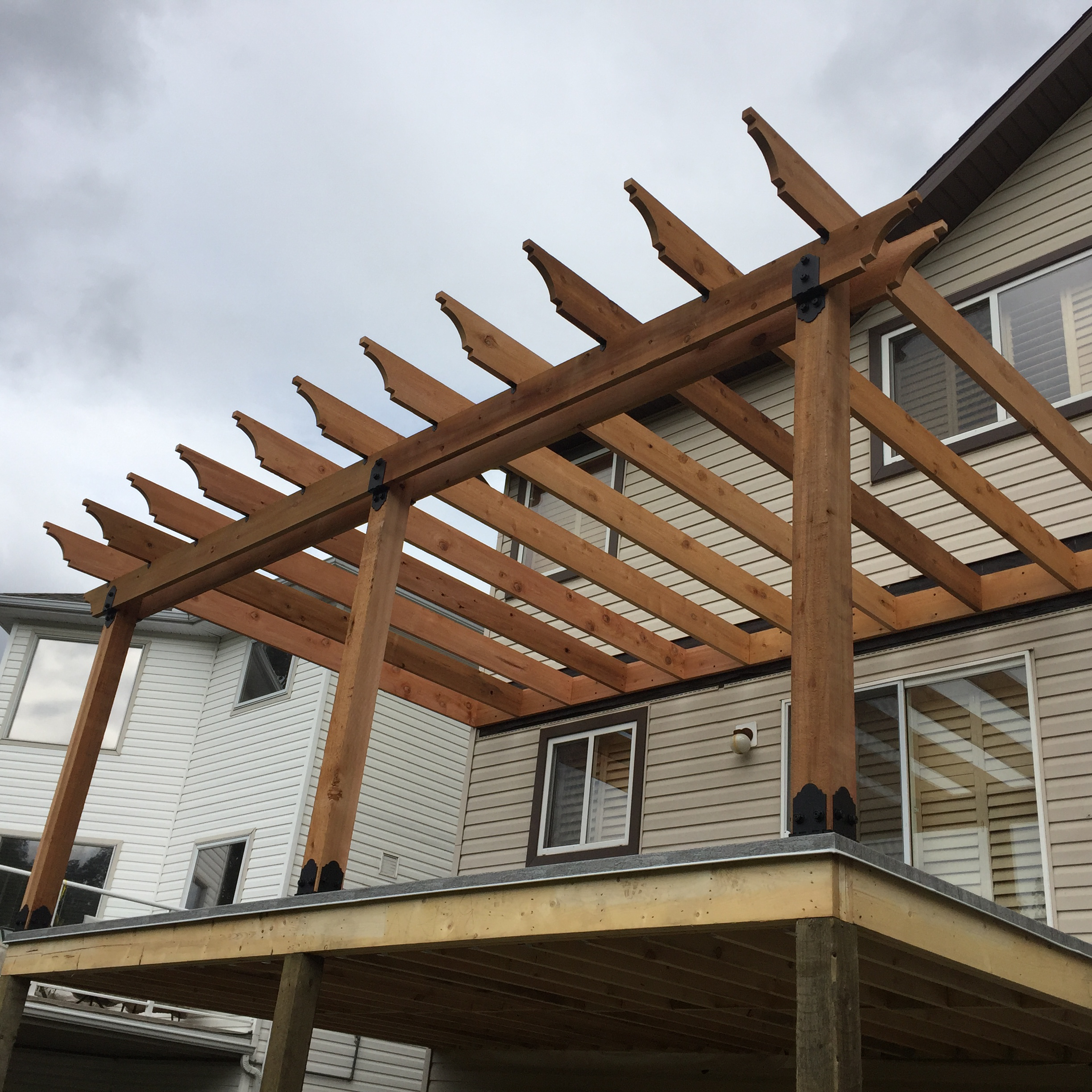 Custom timber pergola with detailed beams and braces
