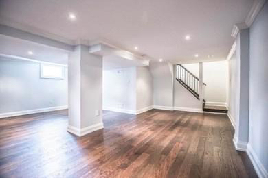 Finished basement with recessed lighting, painted walls and a staircase