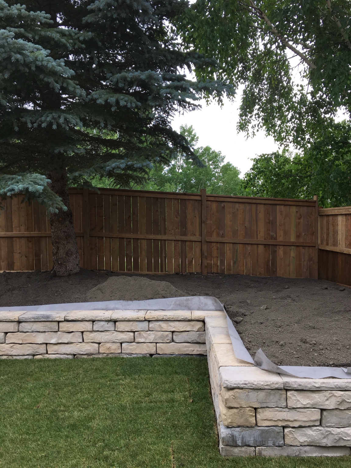 Stone retaining wall and timber fence