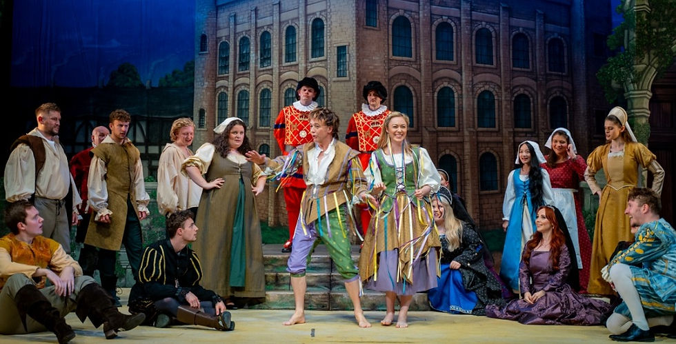 Simon Butteriss and Kelli-Ann Masterson as Jack Point and Elsie Maynard, with chorus, in the National Gilbert & Sullivan Opera Company's The Yeomen of the Guard at Buxton Opera House. cr Charles Smith