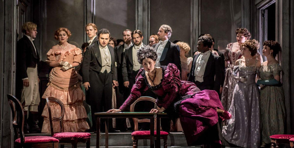 A scene from La Traviata - L-R Frances Gregory (Flora Bervoix), Tigran Melkonyan (Alfredo Germont), Alexandra Nowakowski Violetta) and cast in La Traviata at Buxton International Festival. Pic: Genevieve Girling