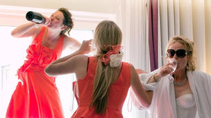 Three women drinking at a wedding party
