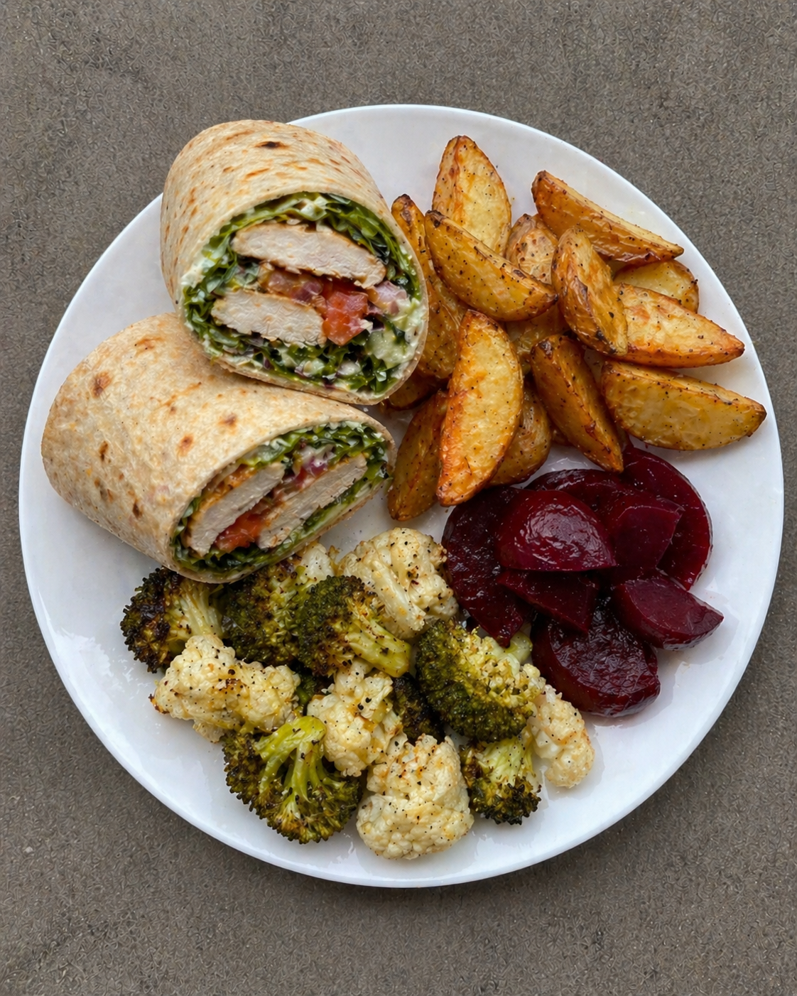 Chicken wraps with potato wedges, beetroot and vegetables.