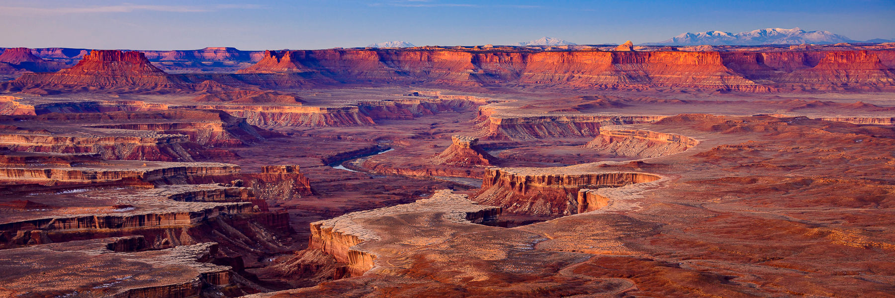 Glowing dawn illuminates the Green River and the rugged landscape in Canyonlands, Utah. Photography print and wall art.