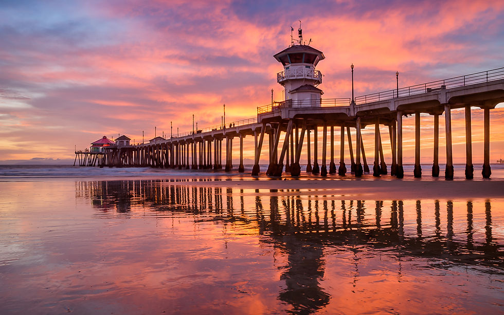 Huntington Beach pier under the cover of sunset glow. Seascape photography print and wall art.