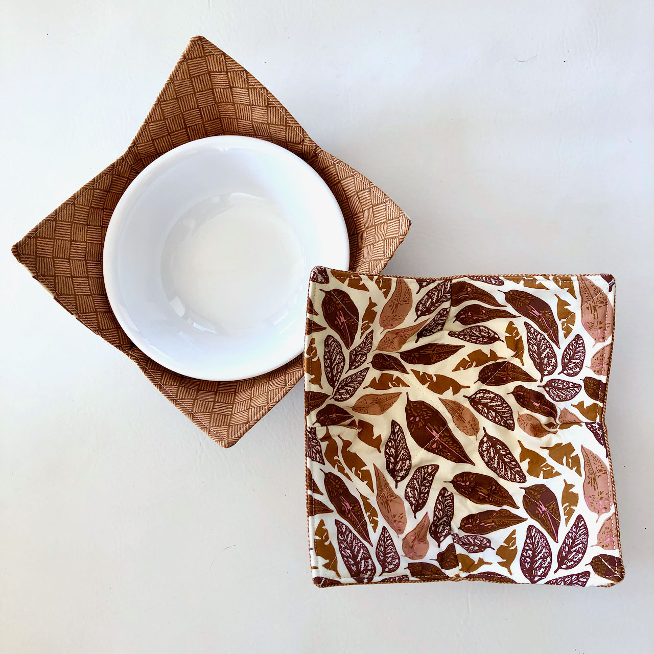 Microwavable reversible bowl cozy with brown and gold autumn leaves patterned fabric