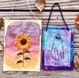 tie dye mounted fabric ghost embroidery flower eyes hanging from string, 3D sunflower art with watercolor sunset