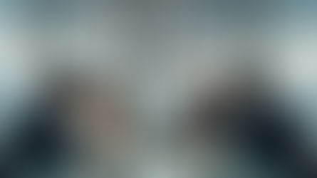 Indonesian business leaders in a modern Jakarta office discussing strategy around a glass table, symbolizing culture, compliance, and compassion in HR transformation 2026.