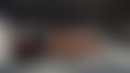 Interior of Wooyoungmi Seoul flagship in Itaewon featuring a minimalist sofa lounge, concrete walls, warm lighting, and quiet luxury design aesthetic.