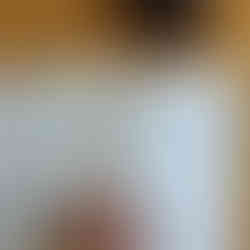 Bookmark inside book with Hebrew text, reading 'יום טוב' on wooden table background