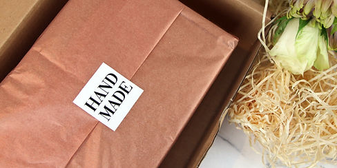 Square sticker with hand-made design applied to seal tissue paper in a box_edited.jpg