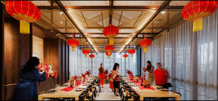 Fat Noodle dining room prepared for Lunar New Year, with red lanterns above long tables.