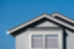 Grey gable house with double window.