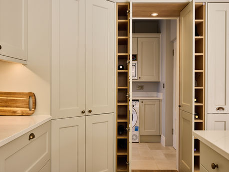 Purley kitchen in Mussel with Shaker cabinetry, concealed utility room, integrated wine storage and brass handles.