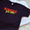 Thumbnail: Unisex T-shirt met de tekst 'Kmoet just niks' casual en eigenwijs statement voor relaxte dagen.