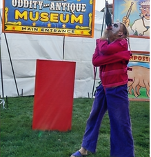Red swallowing a sword in front of Professor Kurio's Travelling Oddity and Antique Museum at the Whitby Rib Festival