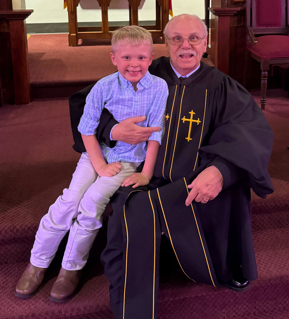 A pastor holds his grandson.