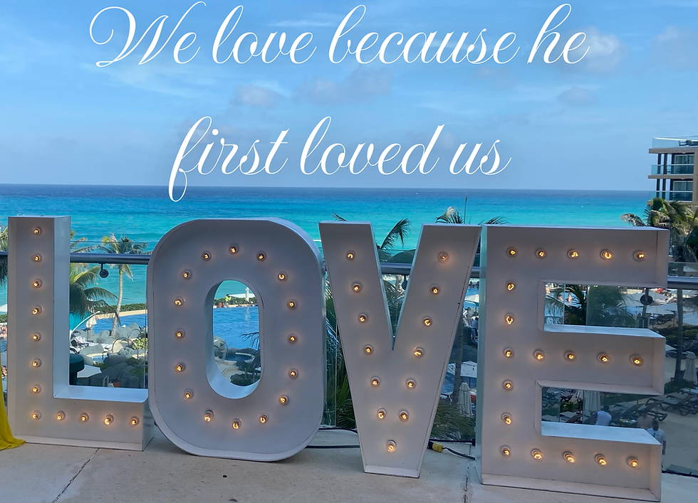 A lighted LOVE sign with a Bible verse