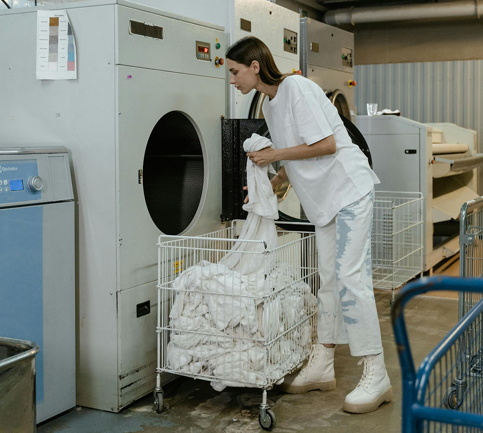 Woman loading washing into a machine.