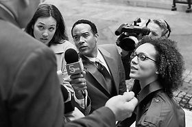 Gruppe von Reportern interviewt eine Person auf der Straße